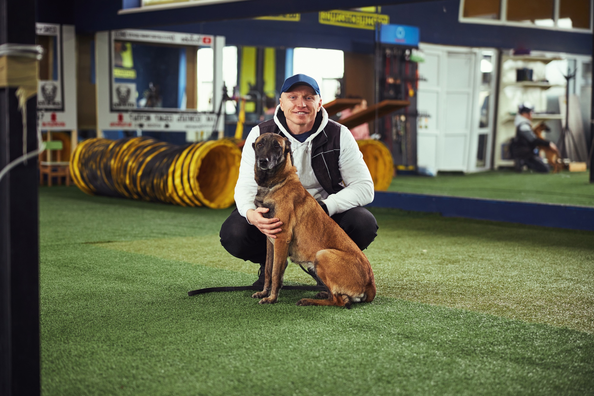 Instructor posing for the camera with a calm adult dog