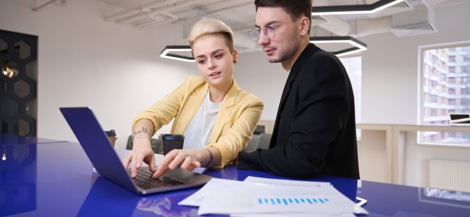 Man and woman developing software on laptop